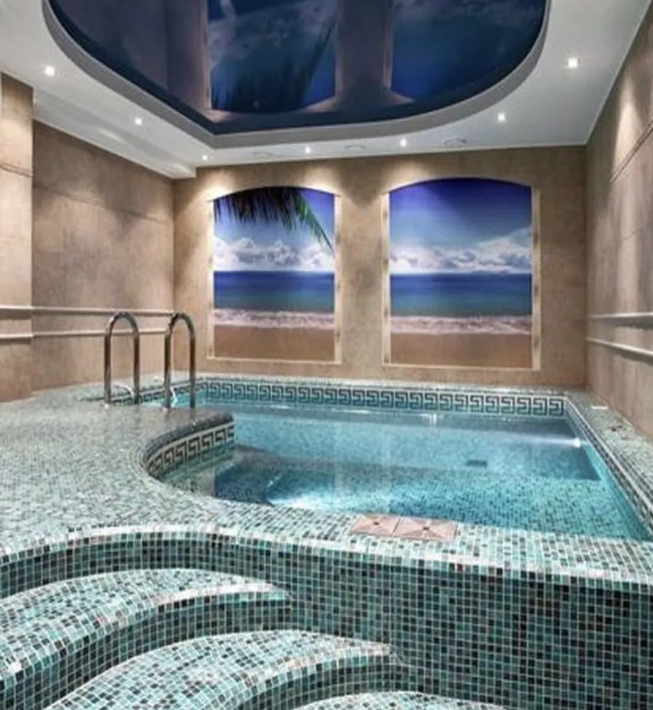 Indoor spa clad in green glass mosaic tile